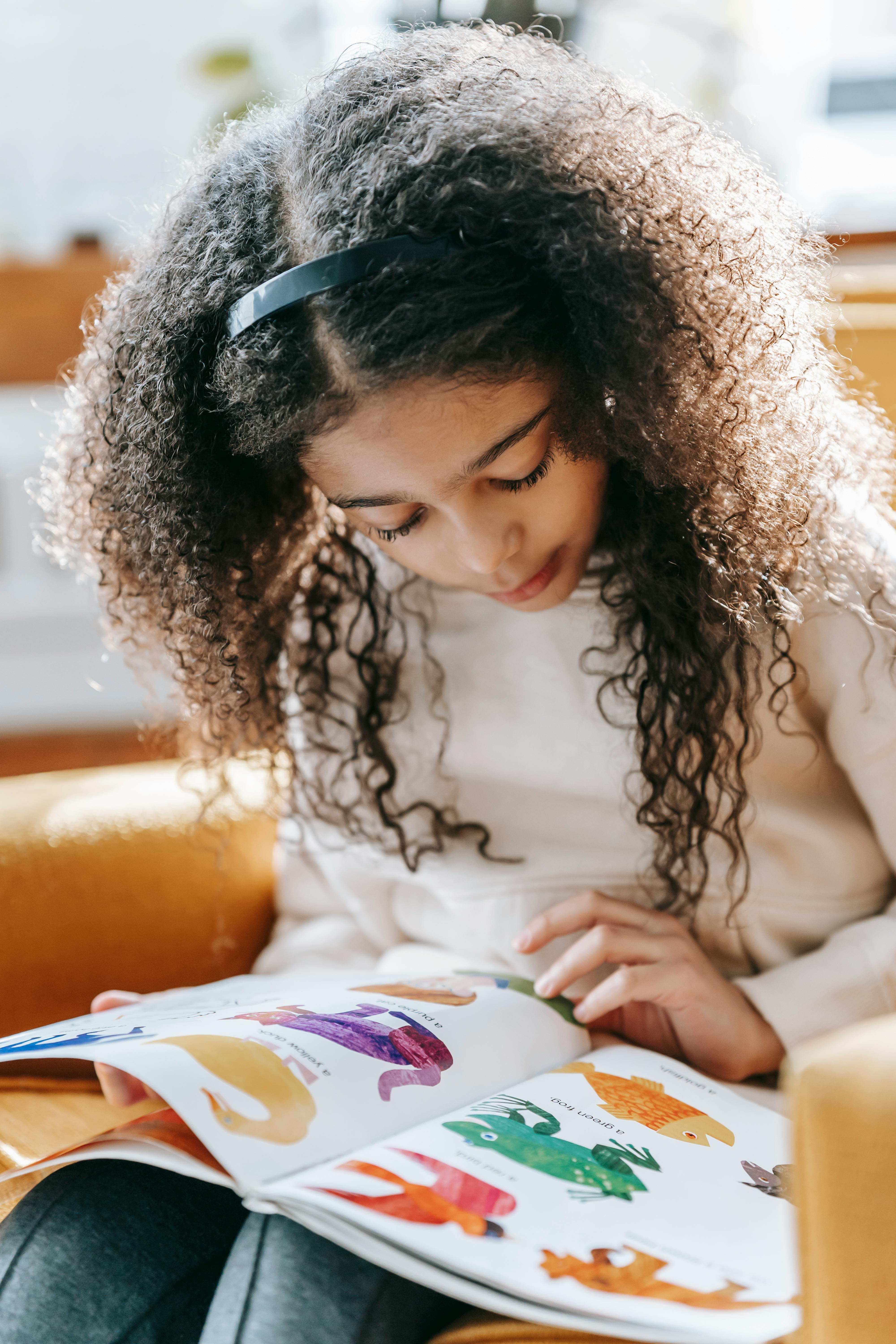 Young student is reading as part of her personalized education plan in OnePoint SIS. 